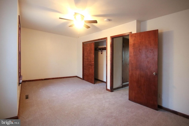 unfurnished bedroom featuring ceiling fan, a closet, and light colored carpet