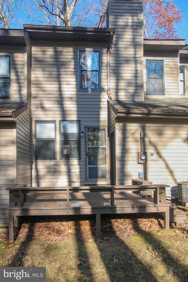 view of property exterior featuring central AC unit and a wooden deck