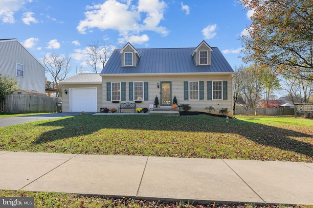 view of front of house with a garage and a front lawn