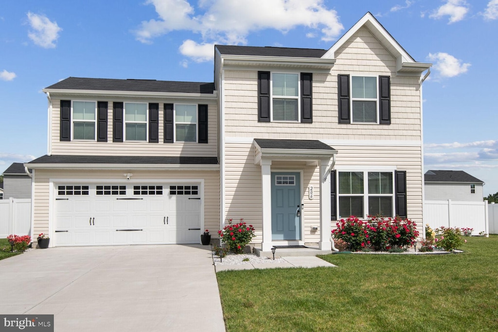 view of front of home featuring a front lawn and a garage