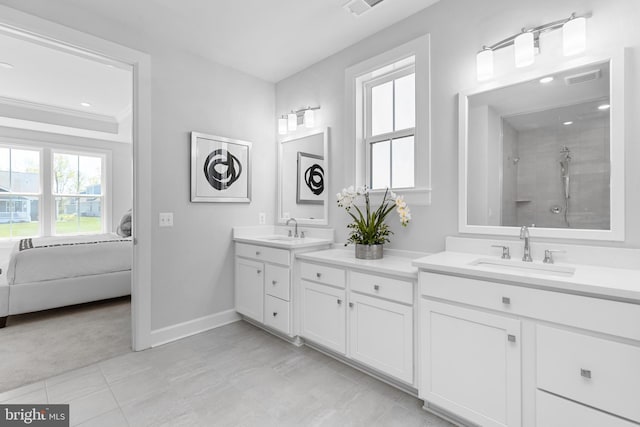 bathroom with tile patterned flooring, a tile shower, vanity, and ornamental molding