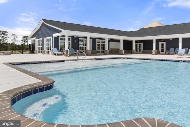 view of pool with french doors and a patio area