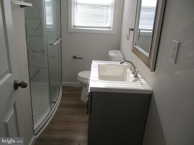 bathroom featuring vanity, hardwood / wood-style flooring, toilet, and an enclosed shower