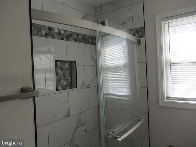 bathroom featuring a shower with door