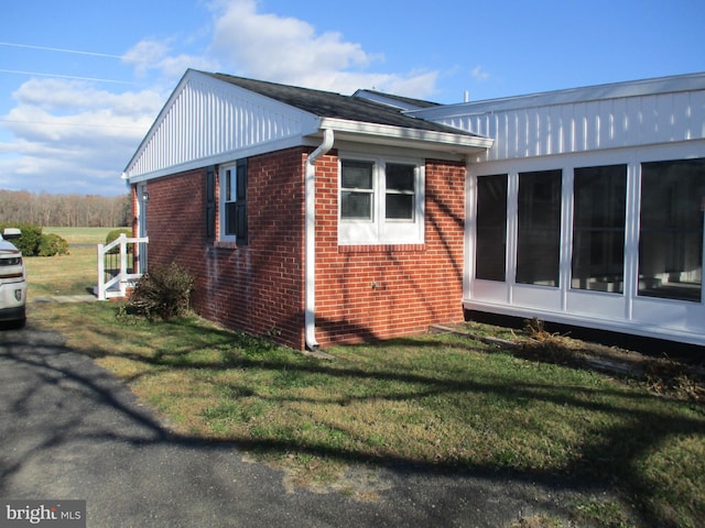 view of side of property with a yard