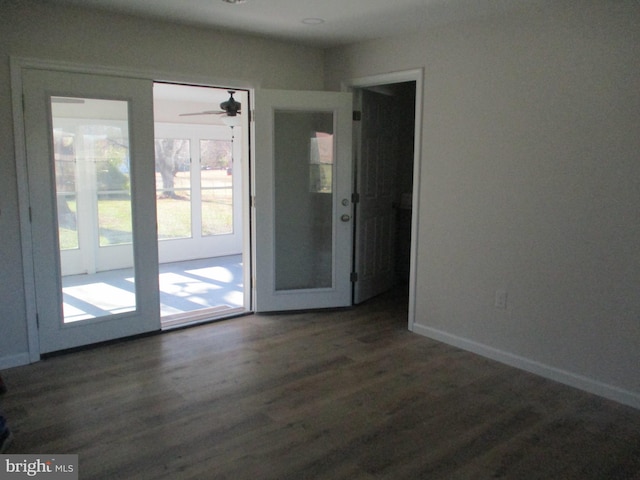 empty room featuring ceiling fan and dark hardwood / wood-style flooring