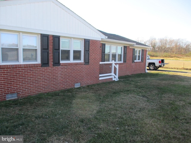 view of side of home featuring a yard