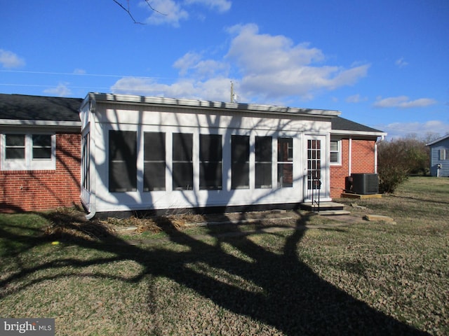 22403 Marsh Creek Rd, Preston, MD 21655 - rear view of property featuring brick siding, central AC, a lawn, and entry steps