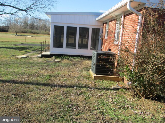 22403 Marsh Creek Rd, Preston, MD 21655 - view of side of property featuring a sunroom, brick siding, and central AC