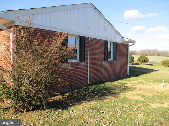 view of side of home featuring a lawn