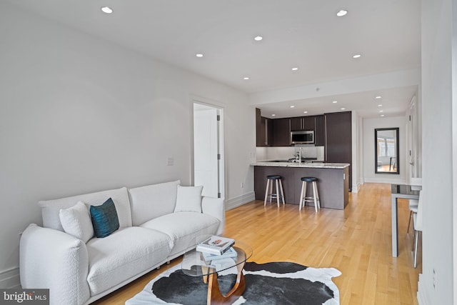 living room with light hardwood / wood-style flooring