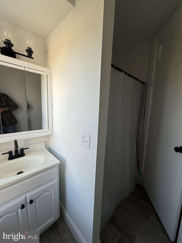 bathroom with tile patterned flooring, vanity, and curtained shower