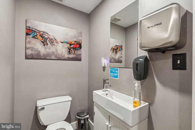 bathroom featuring vanity and toilet