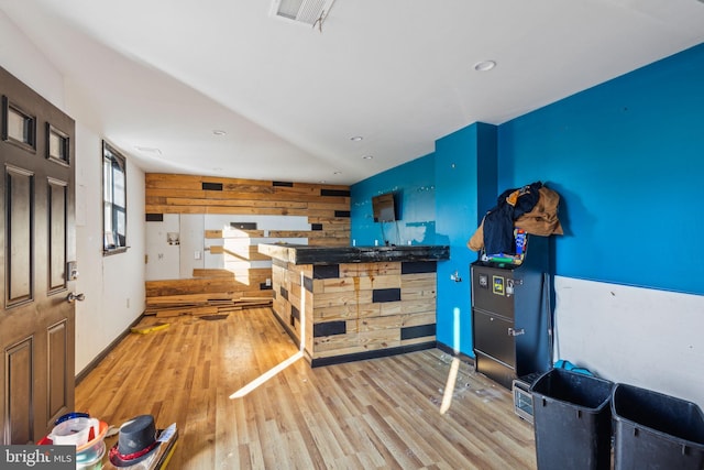 interior space featuring wood-type flooring and wood walls