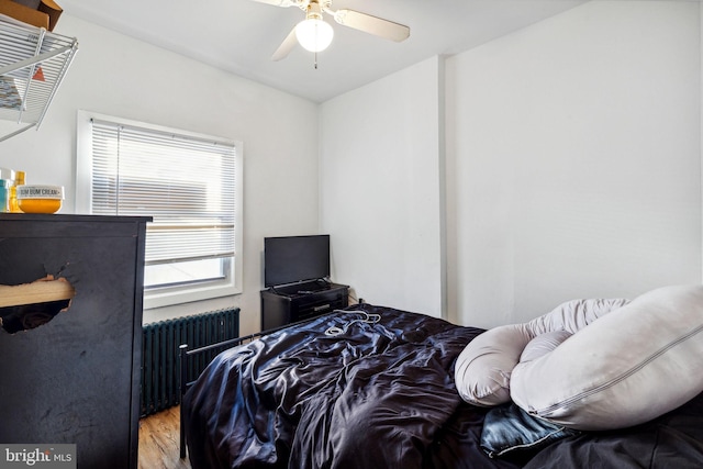 bedroom featuring radiator, ceiling fan, and hardwood / wood-style floors