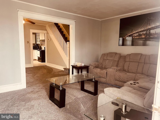 carpeted living room with crown molding and ceiling fan