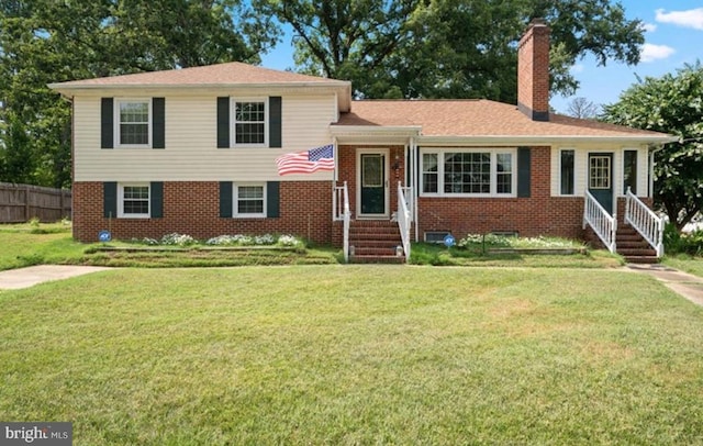 tri-level home featuring a front lawn