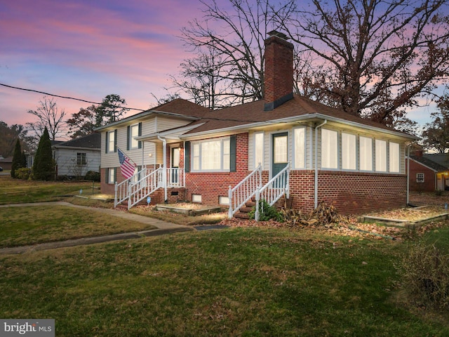 view of front of house with a yard