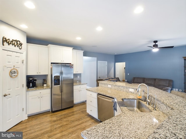 kitchen featuring ceiling fan, white cabinetry, sink, and appliances with stainless steel finishes