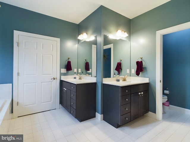 bathroom featuring tile patterned flooring, vanity, and toilet