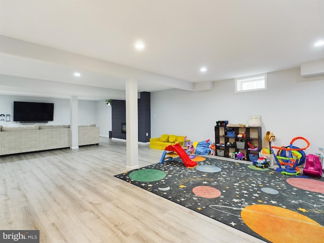 game room with light hardwood / wood-style floors