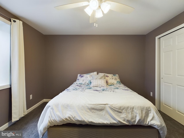 carpeted bedroom with ceiling fan and a closet