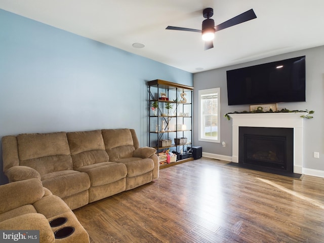 living room featuring ceiling fan and hardwood / wood-style floors