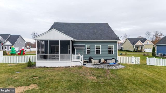 back of house with a yard, a patio, central AC unit, and a sunroom