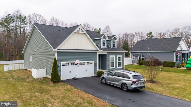 view of front of house featuring a garage and a front lawn