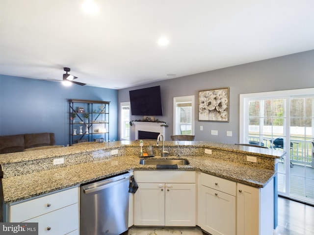 kitchen with ceiling fan, sink, stone countertops, dishwasher, and white cabinetry