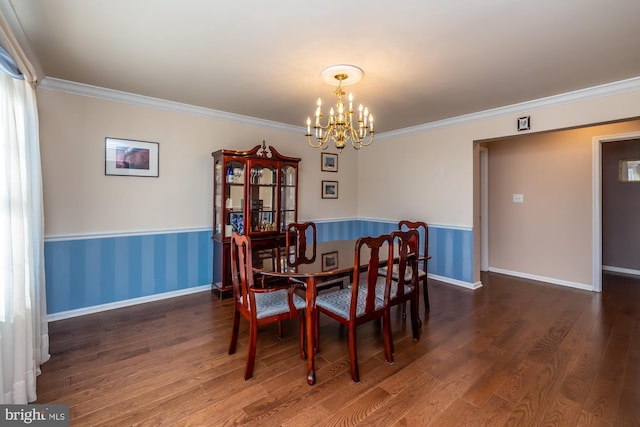 dining space featuring an inviting chandelier, dark wood-type flooring, and crown molding