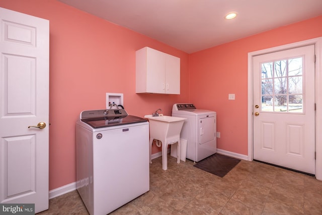 clothes washing area featuring cabinets, separate washer and dryer, and sink