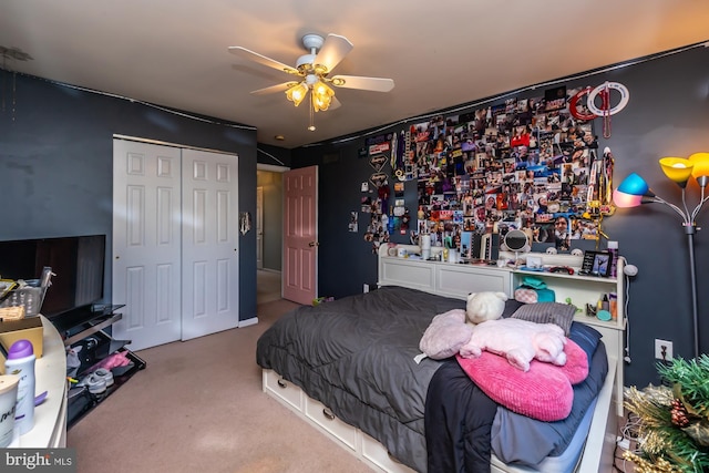 carpeted bedroom featuring ceiling fan and a closet