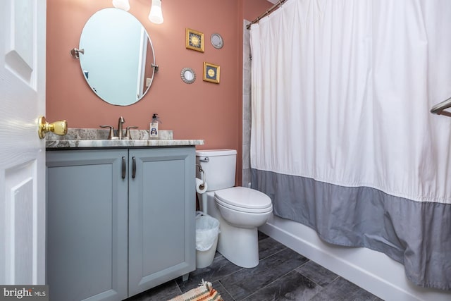 full bathroom with shower / bathtub combination with curtain, vanity, and toilet