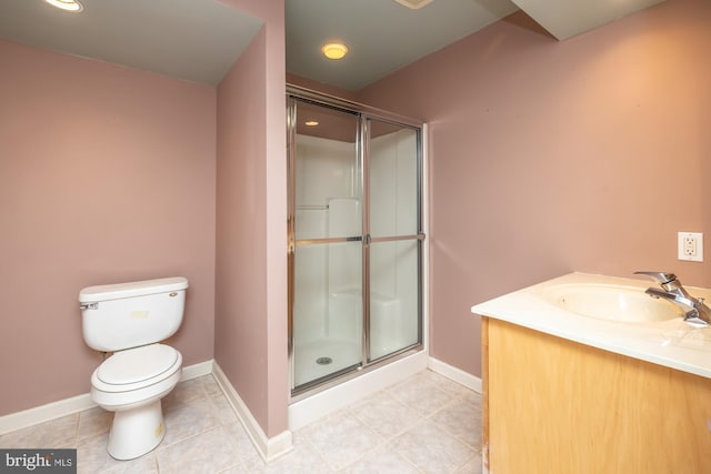 bathroom with tile patterned flooring, vanity, toilet, and a shower with shower door