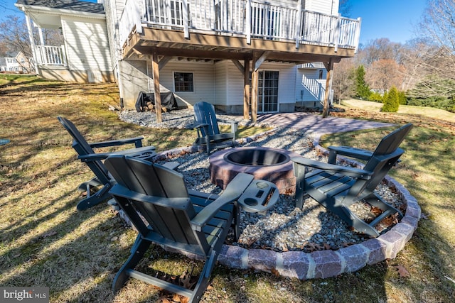 view of patio / terrace with a wooden deck and a fire pit