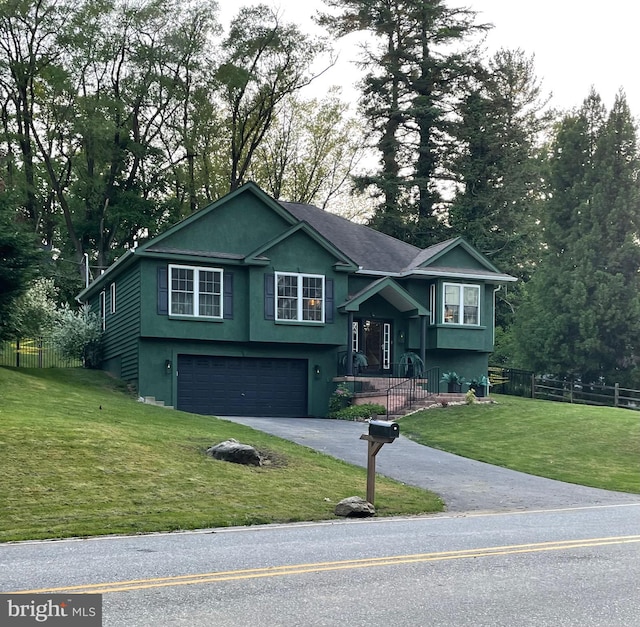 bi-level home featuring a front yard and a garage