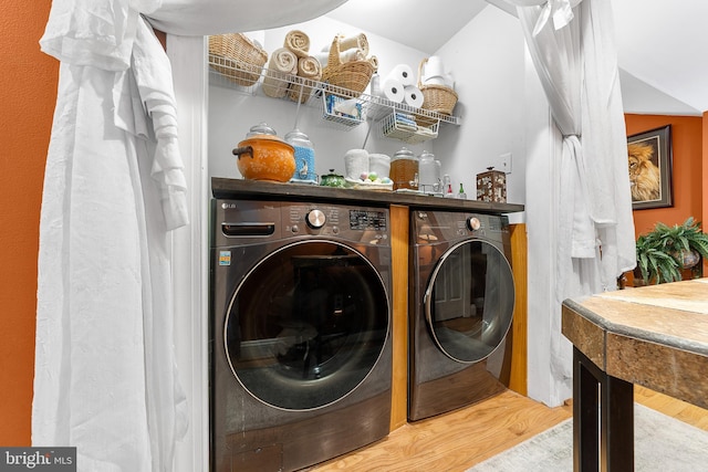 laundry room featuring separate washer and dryer and wood-type flooring