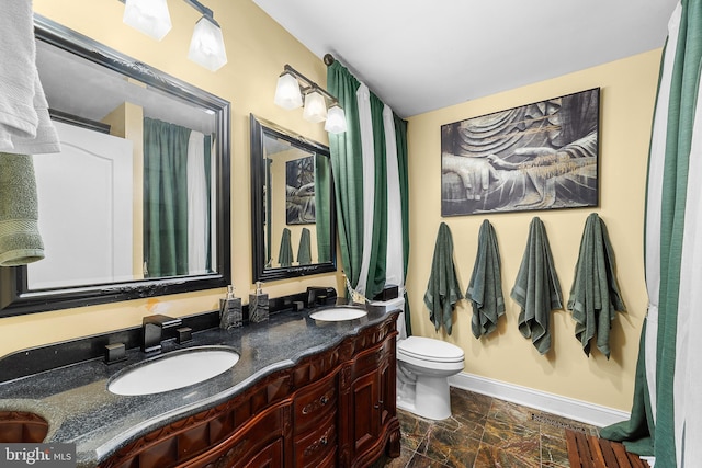 bathroom featuring toilet and vanity