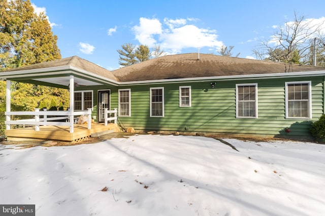 rear view of house featuring a deck