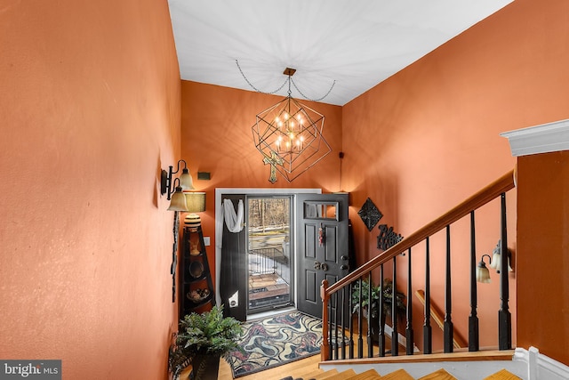 entryway featuring wood-type flooring and an inviting chandelier