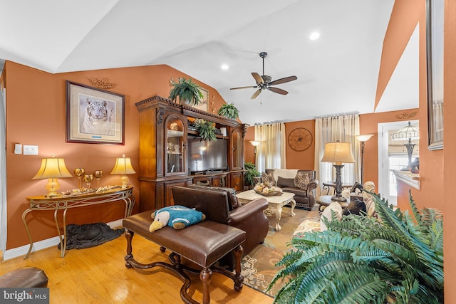 living room featuring ceiling fan, lofted ceiling, and hardwood / wood-style flooring