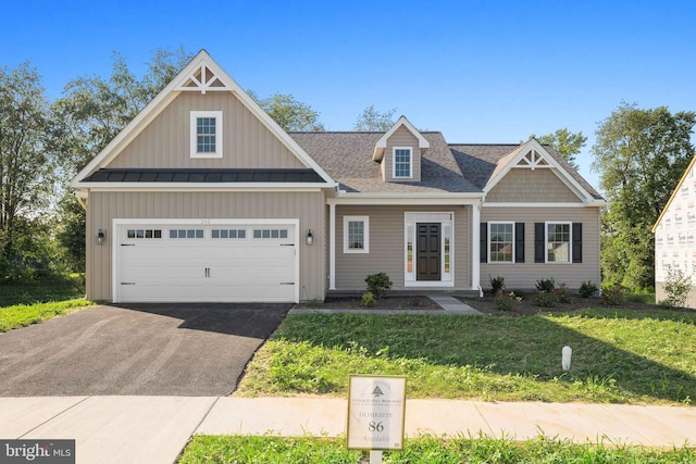 view of front facade featuring a front yard and a garage