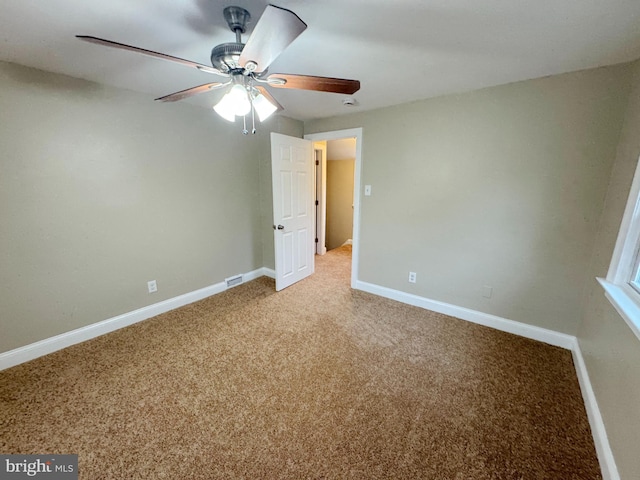 unfurnished bedroom featuring ceiling fan and carpet