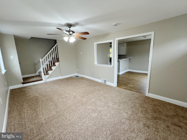 carpeted empty room with ceiling fan