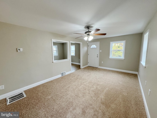 carpeted empty room with ceiling fan