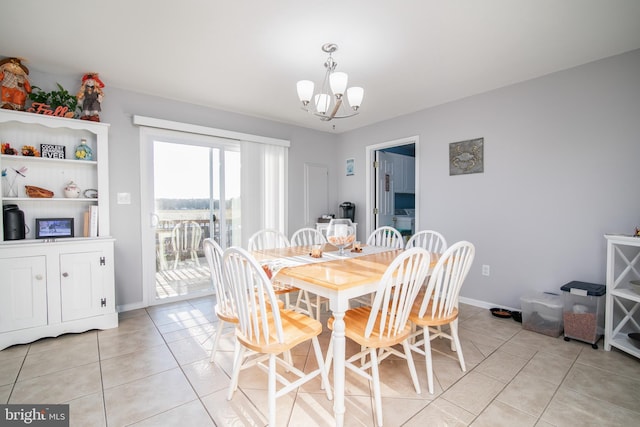 tiled dining area featuring a notable chandelier