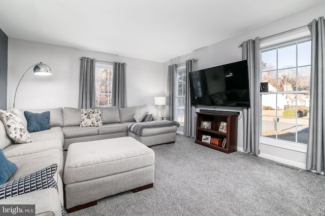 carpeted living room featuring plenty of natural light