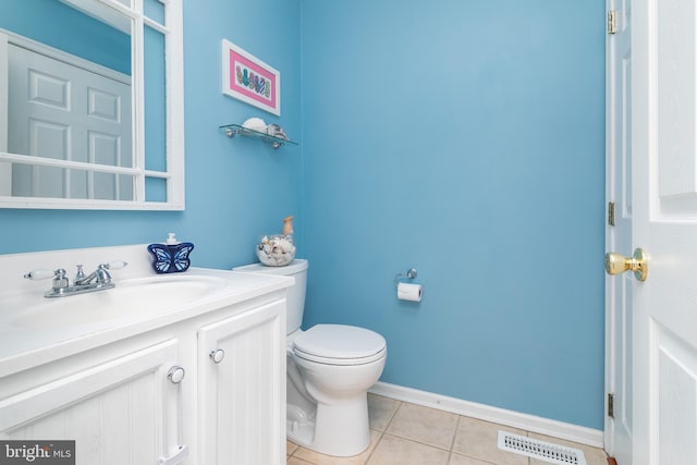 bathroom with tile patterned floors, vanity, and toilet