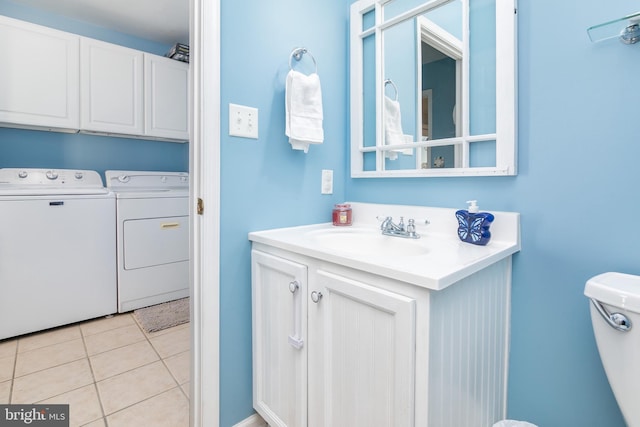 bathroom with separate washer and dryer, tile patterned flooring, vanity, and toilet